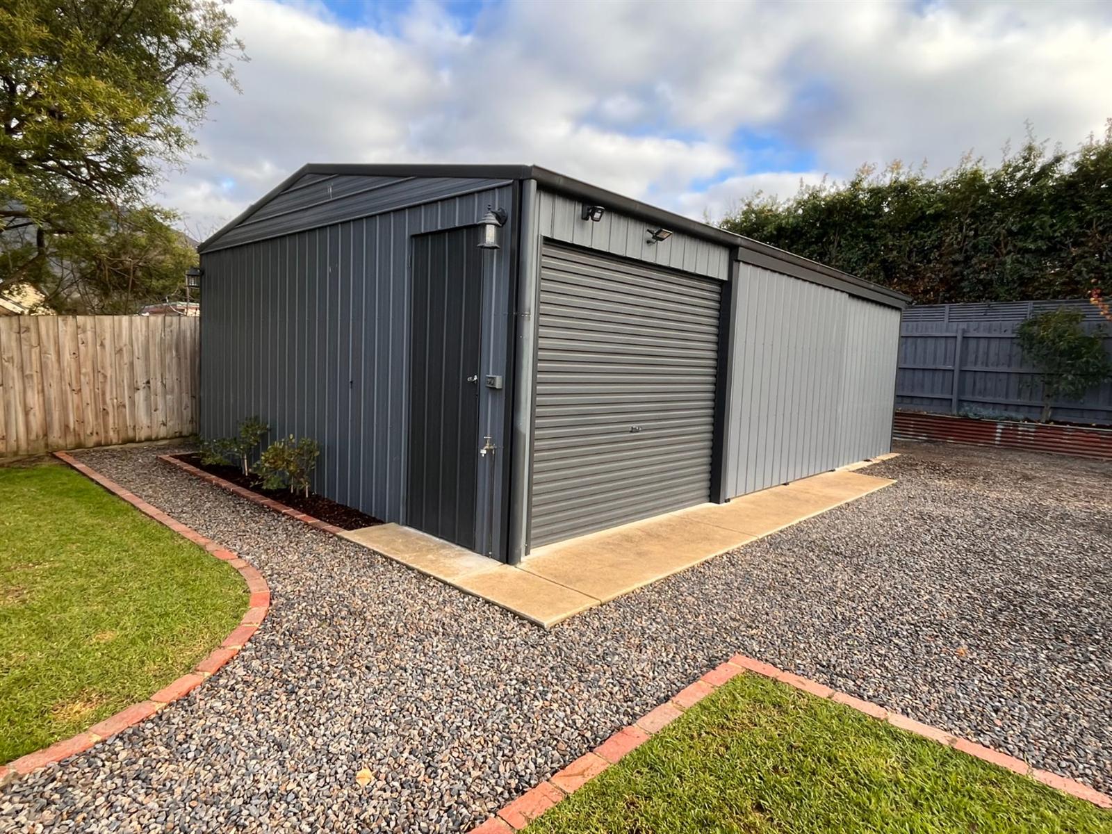 Charcoal workshop with gravel and garden surrounds