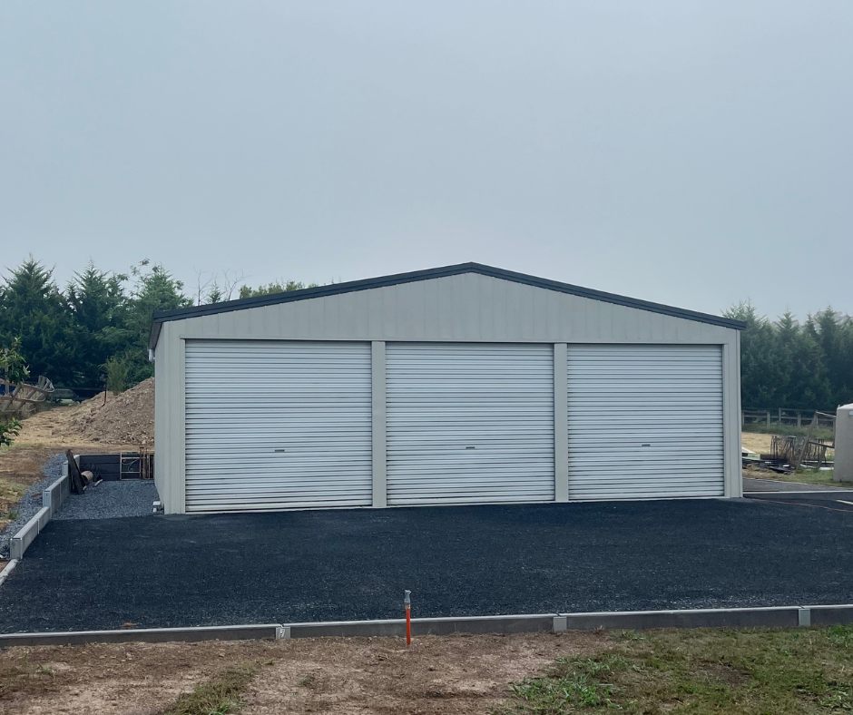 Three-bay shed with roller doors and new gravel driveway